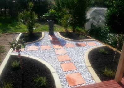 terracotta stepper paths in white pebbles